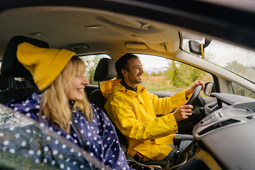 Photo of a smiling couple on a road trip