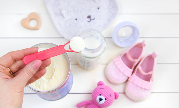 istock baby bottle with milk on white background. Selective focus. 1348234297