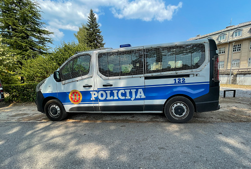 Cetinje, Montenegro, 8-22-2021: Police van is parked near the law enforcement personnel deployed nearby.