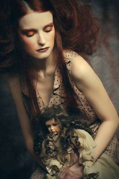 istock Beautiful lady with artistic make-up with doll 1348236238