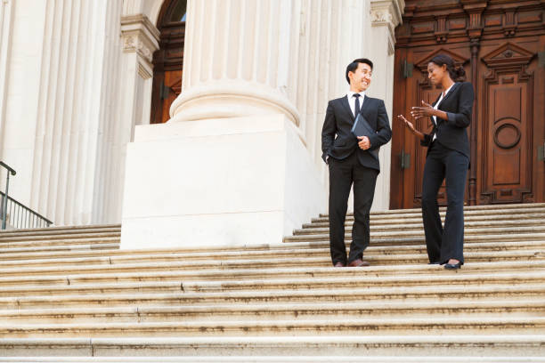 istock Cheerful Man on Woman Walk Down Courthouse Steps 1348236502