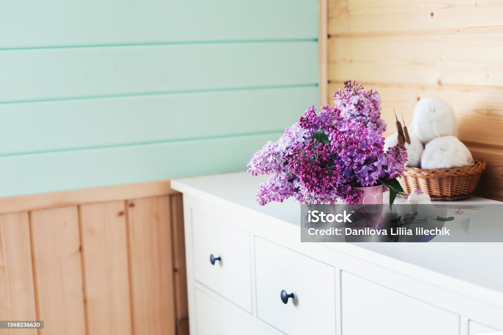 Crochet and knitting. Women's working space. Bouquet of lilac, yarn, crochet hooks on the table. Favorite hobby. Purple Stock Photo