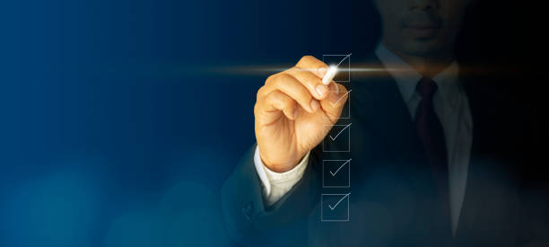 Checklist concept businessman checking mark on the checkboxes Checklist concept businessman checking mark on the checkboxes with marker white with a virtual screen, modern on dark blue background concept, can put your text at the pen, copy space list stock pictures, royalty-free photos & images