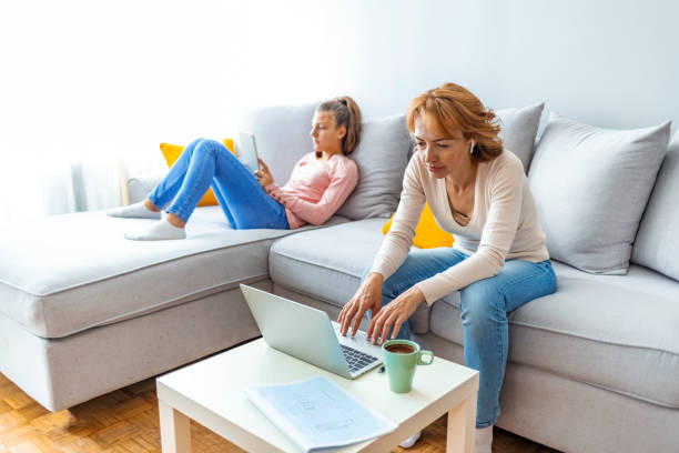 istock Mother Using Laptop In Home Office 1348240398