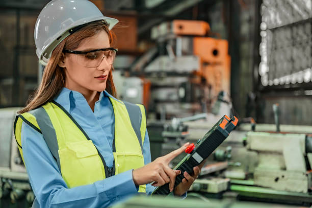 istock A female engineer holds tool equipment and working inside factory. 1348240478