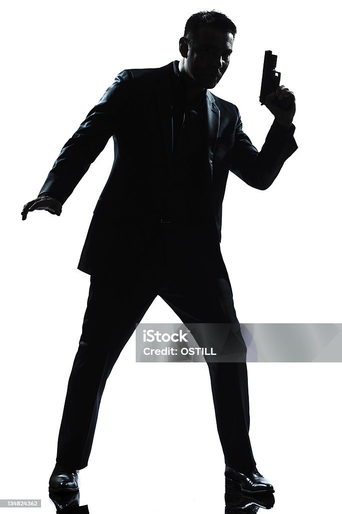 silhouette uomo spia holding Pistola - Foto stock royalty-free di Arma da fuoco