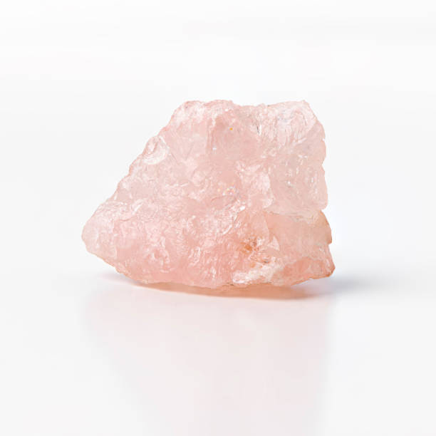 istock Rose quartz raw silicon dioxide mineral isolated on white background. 1348245770