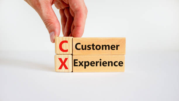 istock CX customer experience symbol. Concept words 'CX customer experience' on wooden blocks on white table, white background, copy space. Businessman hand. Business and CX customer experience concept. 1348247143