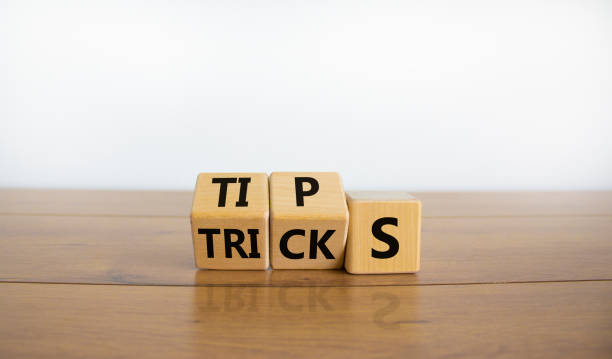 istock Tips and tricks symbol. Tured cubes and changed the word 'tricks' to 'tips'. Beautiful wooden table, white background. Business, tips and tricks concept. Copy space. 1348247152