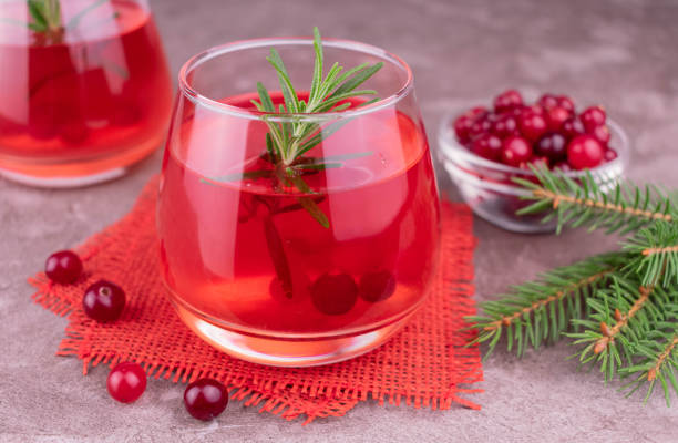 istock Red cocktail made from fresh cranberries on a gray background. 1348247923