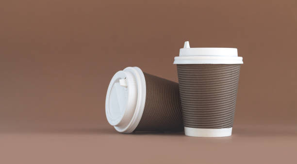 istock Banner of two paper corrugated coffee cup with cap 1348248709