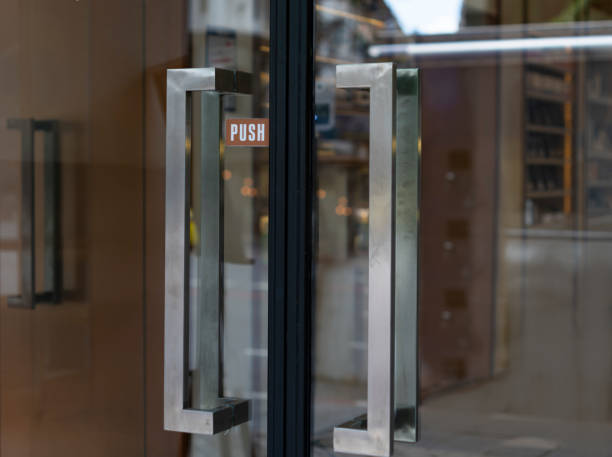 istock Restaurant door handle with push sign on glass doors 1348249263