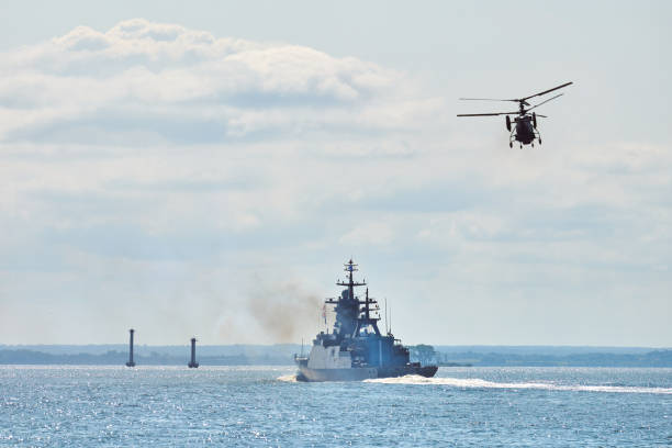 istock Battleship war ship corvette during naval exercises and helicopter maneuvering over sea, warships 1348250379
