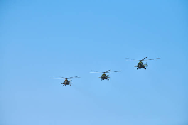 istock Three military helicopters flying in blue sky performing demonstration flight, air show, copy space 1348250427