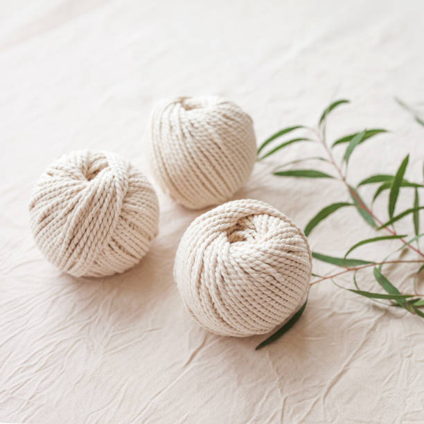 istock Handmade macrame braiding and cotton threads. Image good for macrame and handicrafts banners and advertisement.  Top view. Copy space 1348252319