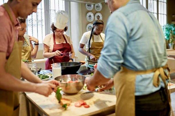 istock Instructor and Adult Students During Team Cooking Event 1348253983