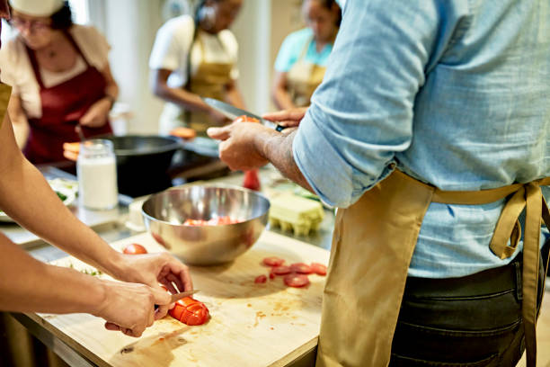 istock Businesspeople Participating in Team Cooking Class 1348253994