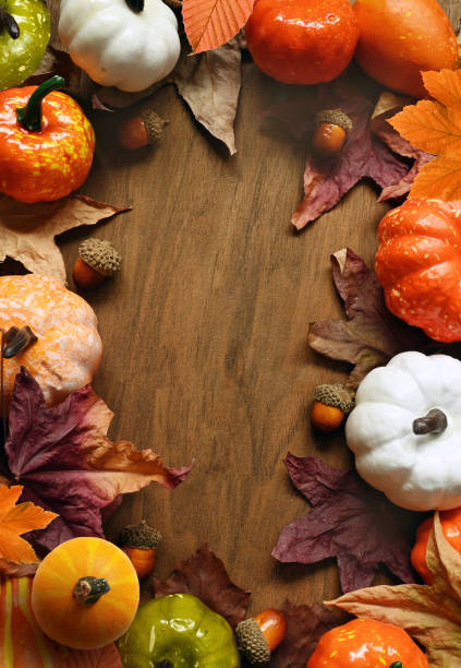 istock Creative pattern, autumn background. Pumpkin and leaves on a wooden background. Halloween. 1348255372