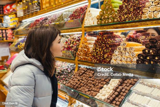 Young Woman Looking At Turkish Delight Various Lokum Colorful Sweets And Chocolate At Store Selling Delight Stock Photo - Download Image Now