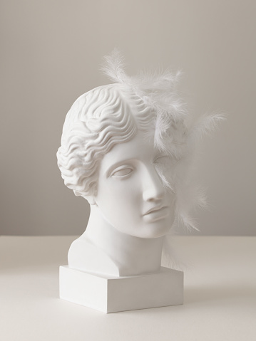 Plaster head model (mass produced replica of Head of an Amazon) with attached feathers