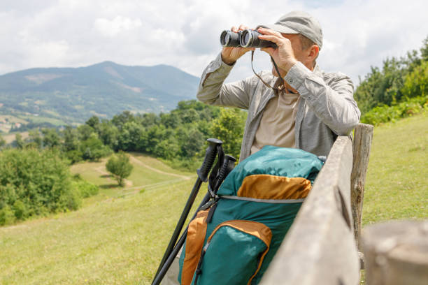 istock Senior man resting and observing nature through binoculars 1348261666