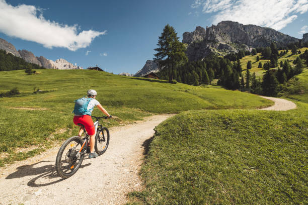 istock Female mountain biker on a trail in Seceda, Dolomites 1348262404