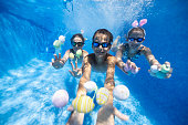 Kids playing underwater during summer Easter