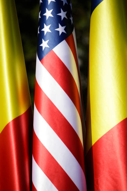 istock United States and Romanian flags on poles one next to another. 1348264395