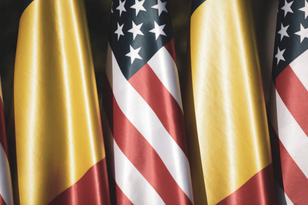 istock United States and Romanian flags on poles one next to another. 1348264461