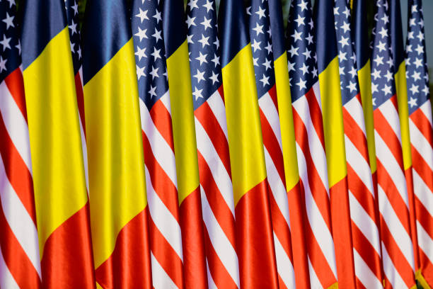 istock United States and Romanian flags on poles one next to another. 1348264751