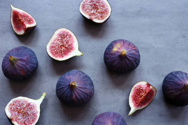 istock Fresh figs on violet background. Beautiful blue violet figs. 1348266120