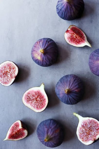 istock Fresh figs on violet background. Beautiful blue violet figs. 1348266470