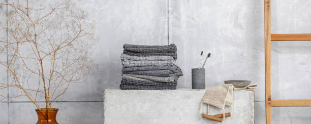 istock Organic waffle linen towels, bamboo toothbrushes, bathroom zero waste accessories in grey shades in contemporary bathroom interior. Daily body care, spa and wellness zero waste bathroom concept 1348272045
