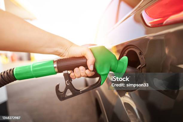 Closeup Of Man Pumping Gasoline Fuel In Car At Gas Station Stock Photo - Download Image Now