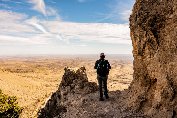 istock Woman Stands at Viewpoint Over Valley 1348273066