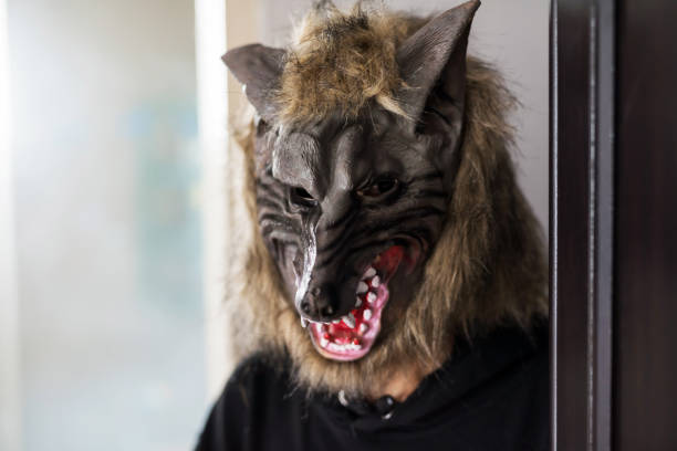 istock man with werewolf mask and black dress. Halloween 1348273371