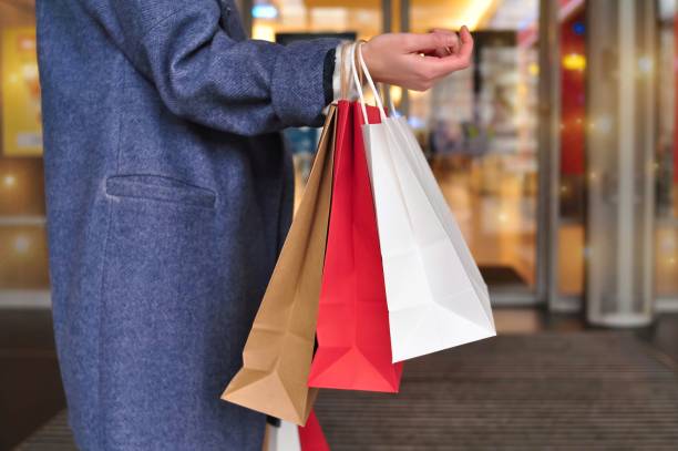 istock customer's hand holding shopping bag 1348274206