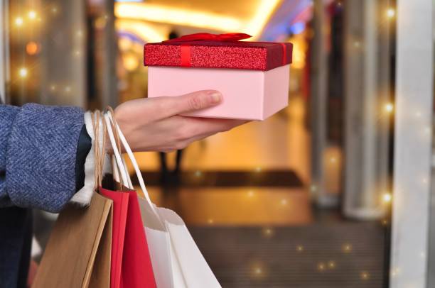 istock customer's hand holding shopping bag 1348274323