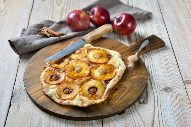 Sweet Alsatian tarte flambée Sweet Tarte Flambée from Alsace with apple rings and candied cinnamon sugar as a dessert hot from the oven pizza topping stock pictures, royalty-free photos & images