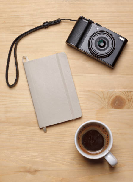istock coffee cup, notepad and vintage photo camera on wooden table 1348279929