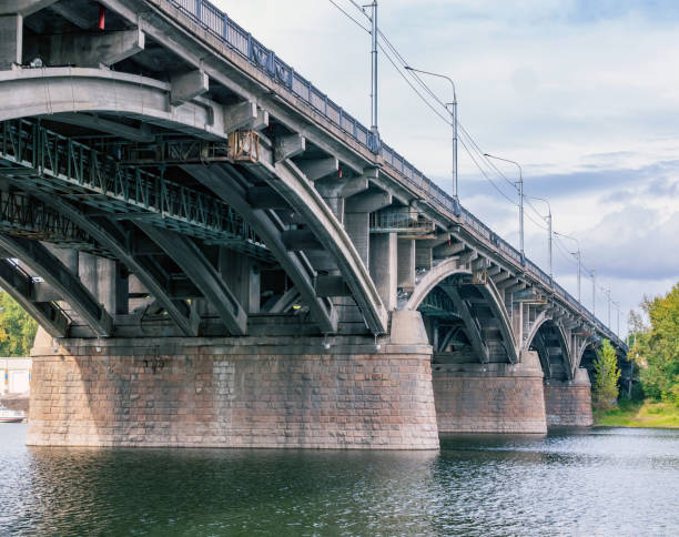 istock Reinforced concrete bridge across the river. Cityscape. 1348281499