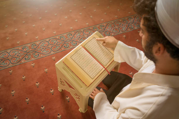 istock Muslim man reading quran in mosque. 1348284083