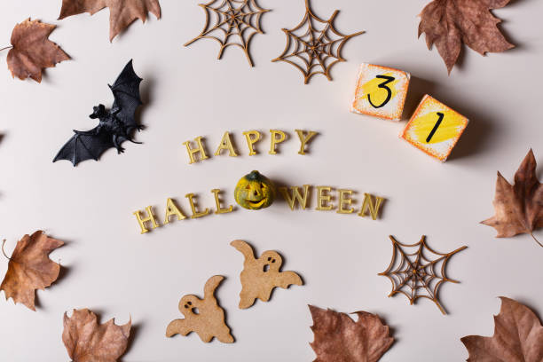 istock Halloween greeting card with ghosts, spiderweb, pumpkin and bats 1348287782