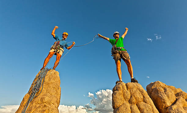 istock Rock climbing team reaching the summit. 134829051