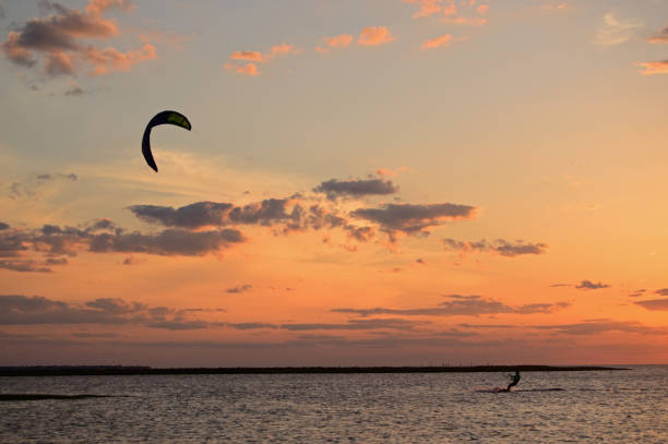 Kite surfing at sunset stock photo