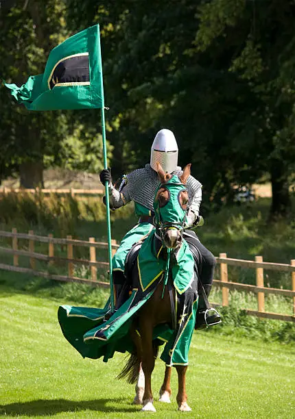 A knight with his standard, waiting to enter the arena at a mediaeval re-enactment event at Castle Fraser, Scotland