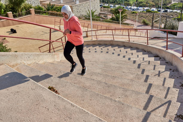 muslim young woman wears a hijab while running - running athlete staircase teenager imagens e fotografias de stock