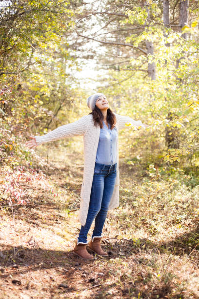 istock young woman enjoying in the forest 1348299204