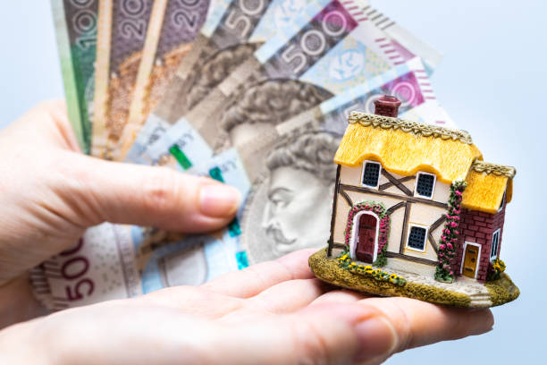 miniature of the house against the background of a large amount of money. polish banknotes, construction concept, costs of building a house or taking a housing loan - house real estate key residential structure imagens e fotografias de stock