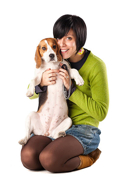 istock Smiling girl with Beagle dog in her lap 134830283